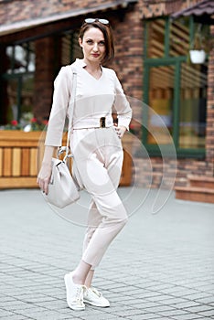 Fashionable young girl posing in the street