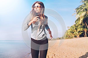 Fashionable young longhaired female have morning jogging on the seaside beach