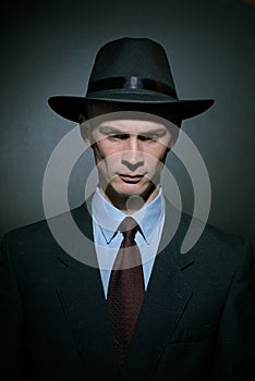 Fashionable young man detective in a stylish hat