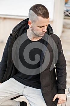 Fashionable young man with a hairdo in a stylish winter