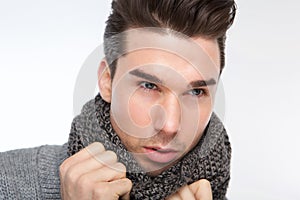 Fashionable young man posing with gray wool scarf