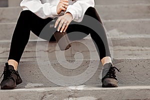 Fashionable young sporty women sitting on the stairs