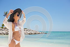Fashionable young woman on the beach