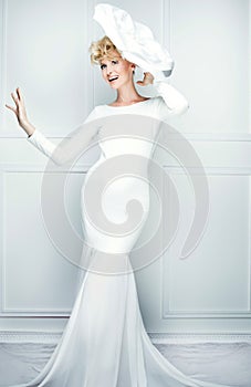 Fashionable young woman posing in white.