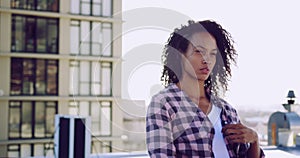 Fashionable young woman on urban rooftop