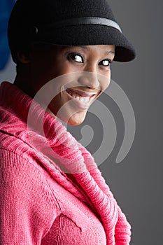 Fashionable Young Woman Wearing Cap And Knitwear photo