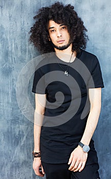 Fashionably dressed man in a cool black outfit posing on the street. Young fashion, Streetstyle.