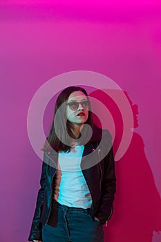 Fashioned girl in leather jacket in dark glasses