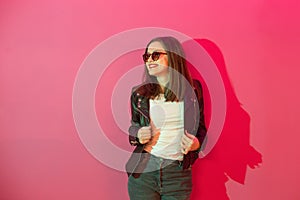 Fashioned girl in leather jacket in dark glasses