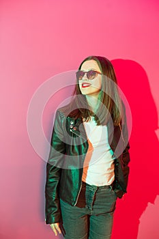 Fashioned girl in leather jacket in dark glasses