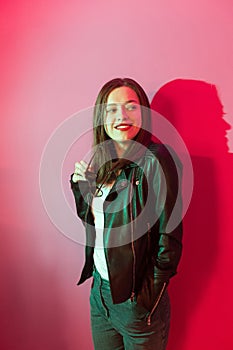 Fashioned girl in leather jacket in dark glasses