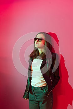 Fashioned girl in leather jacket in dark glasses