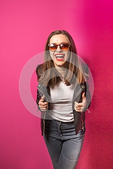 Fashioned girl in leather jacket in dark glasses