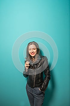 Fashioned girl in leather jacket in dark glasses