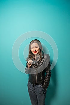 Fashioned girl in leather jacket in dark glasses