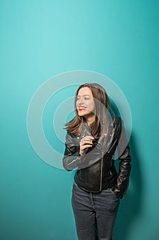 Fashioned girl in leather jacket in dark glasses