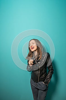 Fashioned girl in leather jacket in dark glasses