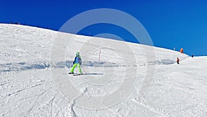 Fast action video of a skiing child going downhill on track