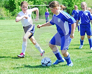 Fast action in youth girls soccer