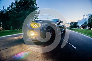 Fast american power muscle car at sunset on road photo