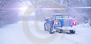 a fast blue sport car on winter snowy day, cold season, street road