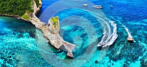 Fast boat at the sea in Bali, Indonesia. Aerial view of luxury floating boat on transparent turquoise water at sunny day. Panorami