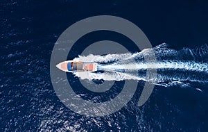 Fast boat at the sea in Bali, Indonesia. Aerial view of luxury floating boat on transparent blue water at sunny day. Summer seasca