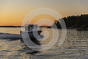 Fast cabin motorboat evening light Stockholm archipelago photo