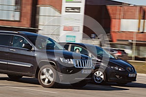 Fast cars, cars driving at high speeds on the street, speeding. Riga, Latvia - 31 Mar 2022