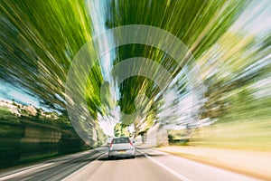Fast And Dangerous Speeding Car On A Highway, Country Asphalt Road. Motion Blur Background