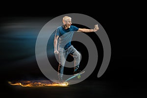 Fast delivery service - deliveryman on skateboard driving with order in fire on dark background
