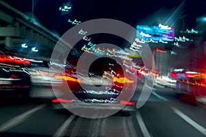 Fast driving traffic at night, blue colors. Abstract blurred background of urban moving car with bright brake lights at