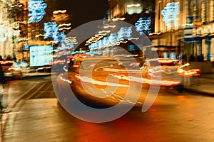 Fast driving traffic at night, neon lights. Abstract blurred background of urban moving car. Auto, city street, speed
