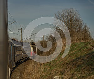 Fast electric train with coaches from Brno to Plzen in spring morning