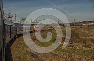 Fast electric train with coaches from Brno to Plzen in spring morning