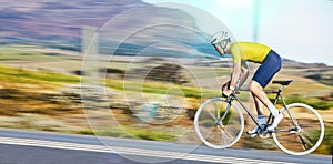 Fast, fitness and a man cycling on the road for cardio, sports or marathon training on a bike. Focus, exercise and a