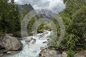 Fast flowing river flowing from Les Grands Jorasses, Italy