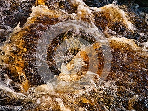 Fast flowing, tumbling, peat stained water in the Yorkshire Dales, Yorkshire, England, UK