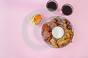 Fast food chicken nuggets with ketchup, french fries, baked mushrooms and cola.