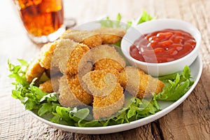 Fast food chicken nuggets with ketchup, french fries, cola