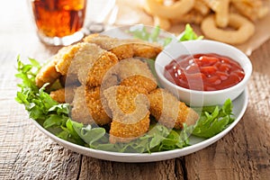 Fast food chicken nuggets with ketchup, french fries, cola