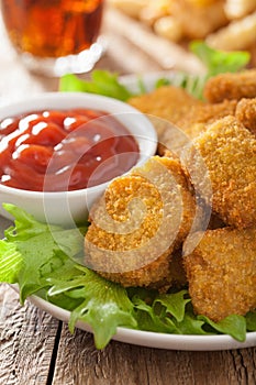 Fast food chicken nuggets with ketchup, french fries, cola