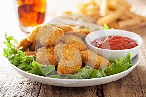 Fast food chicken nuggets with ketchup, french fries, cola