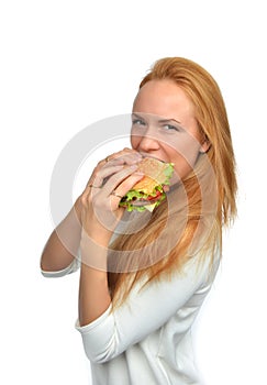 Fast food concept. Woman eating tasty unhealthy burger sandwich