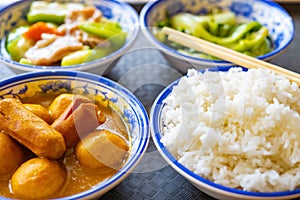 Fast food with curry flavor fish balls and sausages and towel gourd and cabbages and rice horizontal composition