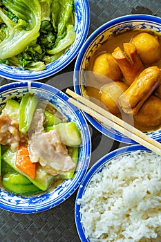 Fast food with curry flavor fish balls and sausages and towel gourd and cabbages and rice vertical composition