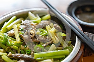 fast food of deep fried little fishes and celery with bowl of soup