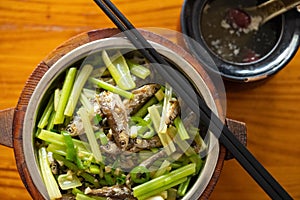 fast food of deep fried little fishes and celery with bowl of soup