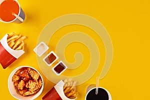 Fast food dish on yellow background. Fast food set fried chicken and french fries. Take away fast food.