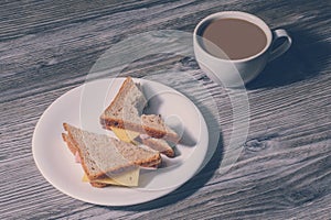 Fast food eating snack breakfast morning fresh education workplace wrkstation concept. Lunch at work. Close up of bitten cheese sa